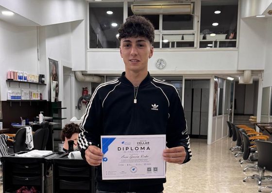 Alumno de barbería con su diploma de la Academia Arturo, con código QR verificable